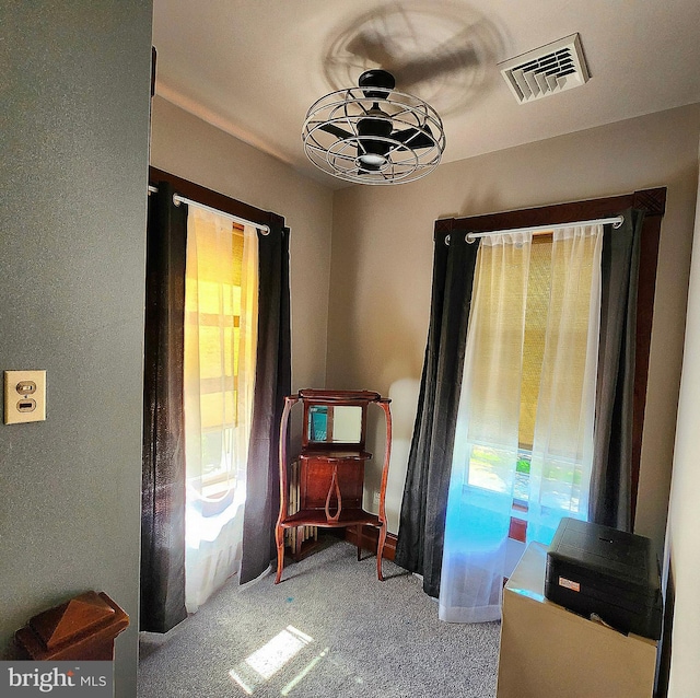 sitting room featuring plenty of natural light and carpet flooring