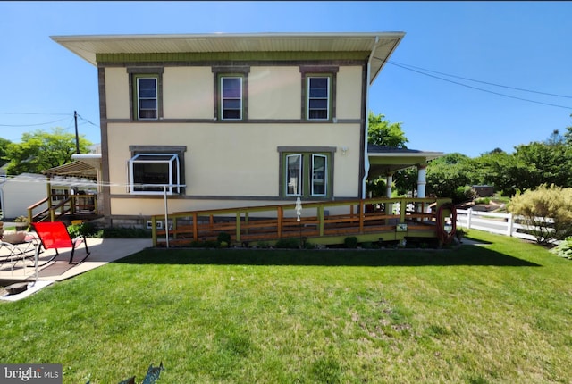 back of property with a patio area and stucco siding