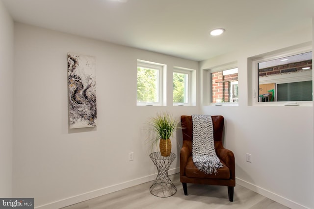 sitting room featuring baseboards, wood finished floors, and recessed lighting