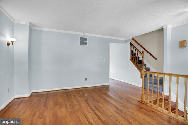 131 Remington Cir, Havre De Grace, MD 21078 - spare room featuring wood finished floors, stairway, baseboards, ornamental molding, and a textured ceiling