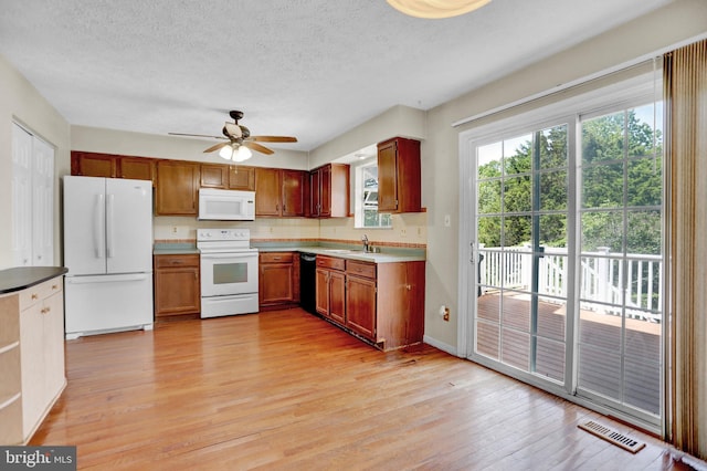 131 Remington Cir, Havre De Grace, MD 21078 - kitchen featuring white appliances, light wood finished floors, a ceiling fan, a textured ceiling, and a sink