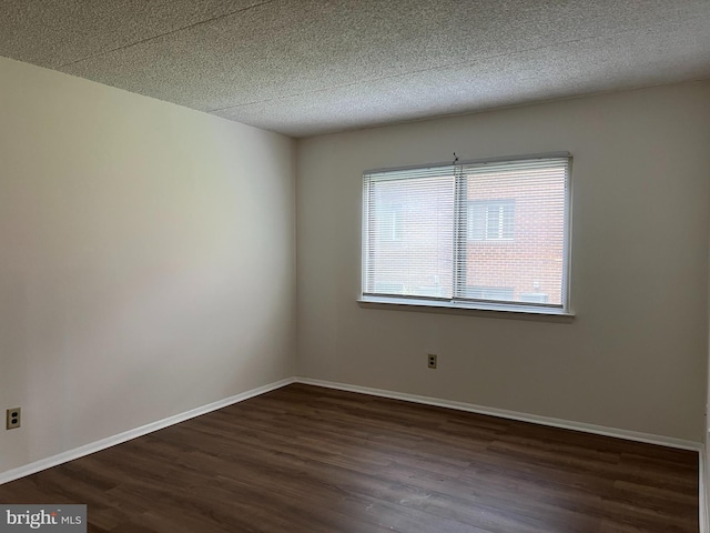 842 Putnam Blvd Unit 60A, Wallingford, PA 19086 - empty room featuring dark wood-style flooring, a textured ceiling, and baseboards