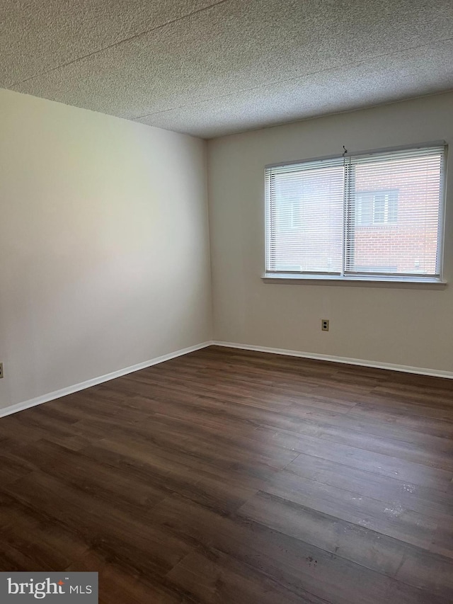 842 Putnam Blvd Unit 60A, Wallingford, PA 19086 - empty room featuring dark wood-style floors, a textured ceiling, and baseboards