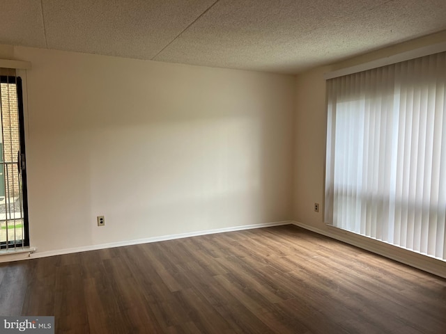 842 Putnam Blvd Unit 60A, Wallingford, PA 19086 - empty room with dark wood-type flooring, baseboards, and a textured ceiling