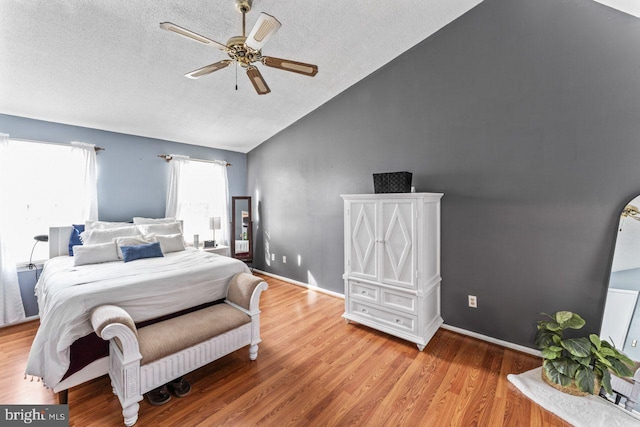 10103 Wimbledon Ct, Manassas, VA 20110 - bedroom featuring lofted ceiling, a textured ceiling, wood finished floors, a ceiling fan, and baseboards