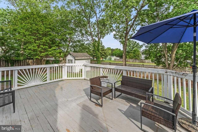 10103 Wimbledon Ct, Manassas, VA 20110 - wooden deck with a fenced backyard, an outbuilding, a storage shed, and an outdoor living space