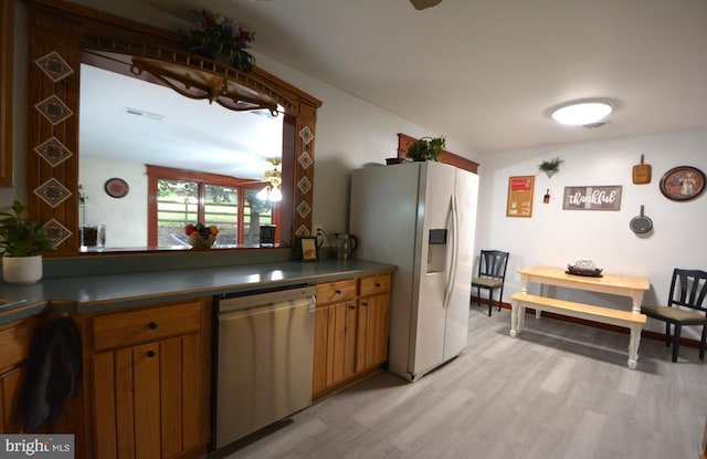 26 Shamrock Cir, Westminster, MD 21157 - kitchen featuring stainless steel appliances, light wood-style floors, dark countertops, and brown cabinetry
