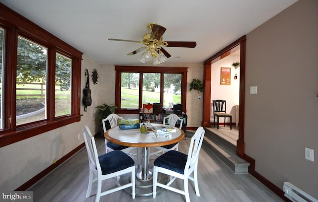 26 Shamrock Cir, Westminster, MD 21157 - dining room featuring baseboard heating, wood finished floors, baseboards, and a ceiling fan