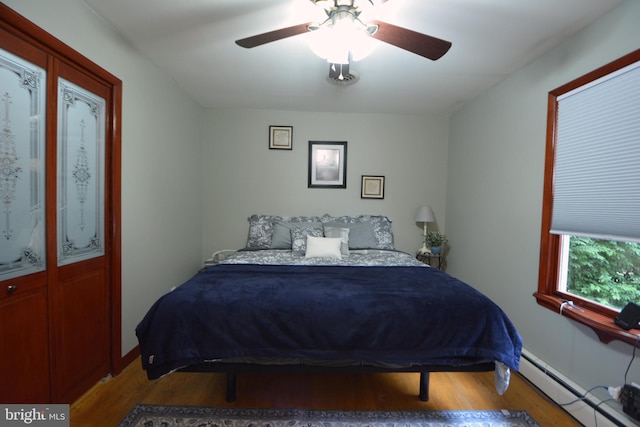 26 Shamrock Cir, Westminster, MD 21157 - bedroom with baseboard heating, wood finished floors, ceiling fan, and baseboards