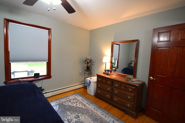 26 Shamrock Cir, Westminster, MD 21157 - bedroom featuring a baseboard radiator, light wood-style flooring, and ceiling fan
