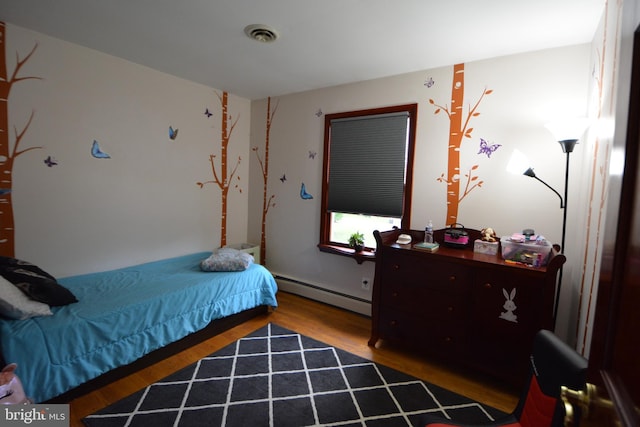 26 Shamrock Cir, Westminster, MD 21157 - bedroom with a baseboard heating unit and wood finished floors