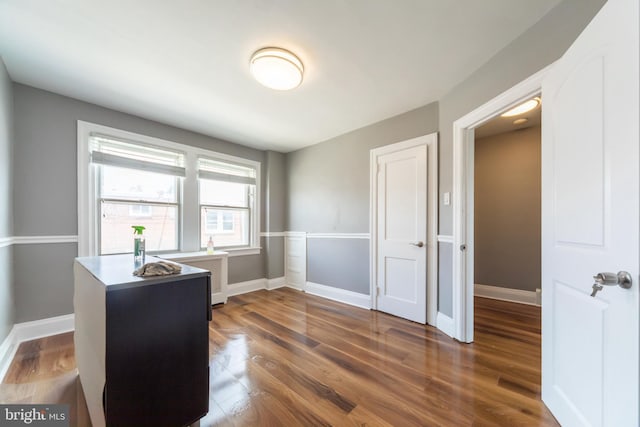 home office with wood finished floors and baseboards