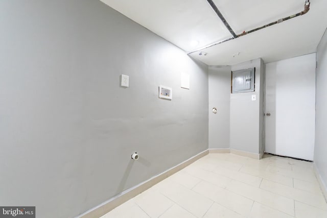 unfurnished room with baseboards and light tile patterned floors