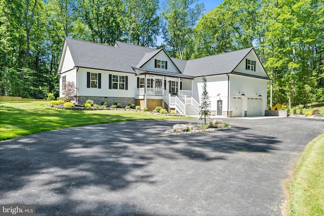 5570 Warren Dr, Huntingtown, MD 20639 - view of front of property featuring driveway, covered porch, a front lawn, stairway, and roof with shingles