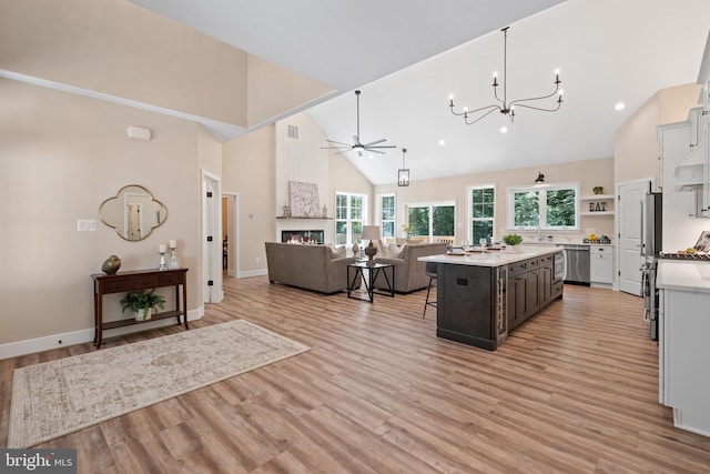 5570 Warren Dr, Huntingtown, MD 20639 - kitchen with high vaulted ceiling, stainless steel appliances, ceiling fan, open floor plan, and a breakfast bar area