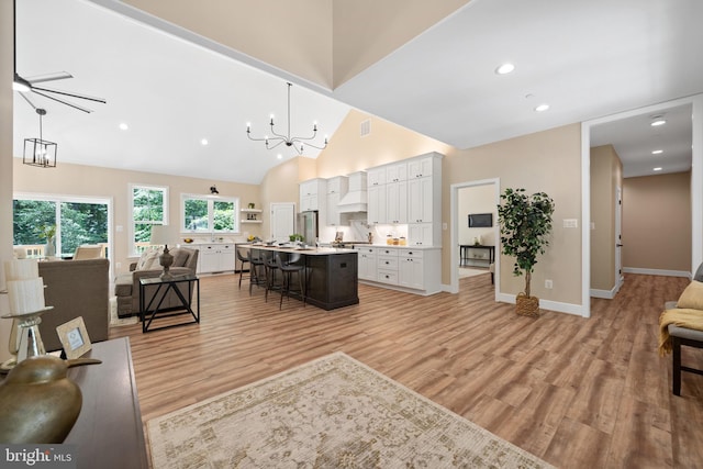 5570 Warren Dr, Huntingtown, MD 20639 - living area with a chandelier, light wood-type flooring, high vaulted ceiling, baseboards, and recessed lighting
