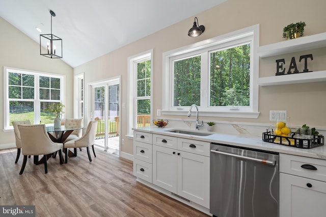 5570 Warren Dr, Huntingtown, MD 20639 - kitchen featuring stainless steel dishwasher, a sink, open shelves, light countertops, and healthy amount of natural light