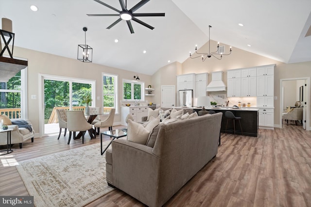 5570 Warren Dr, Huntingtown, MD 20639 - living room with a chandelier, a ceiling fan, light wood-type flooring, high vaulted ceiling, and recessed lighting