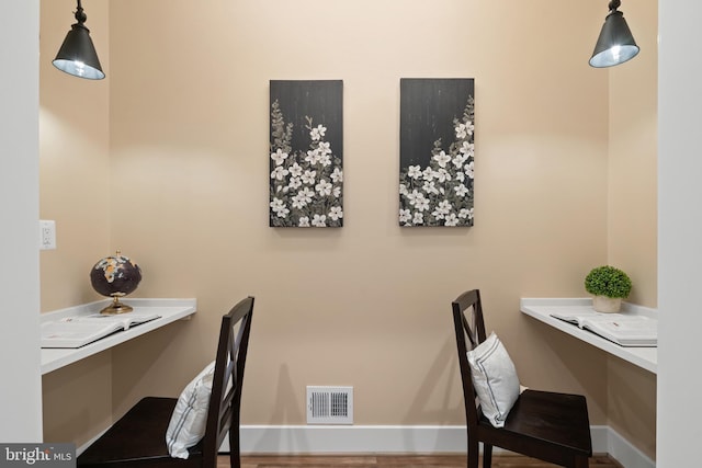 5570 Warren Dr, Huntingtown, MD 20639 - home office featuring built in desk and wood finished floors