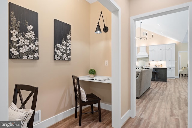 5570 Warren Dr, Huntingtown, MD 20639 - hallway featuring light wood finished floors, a chandelier, lofted ceiling, and baseboards
