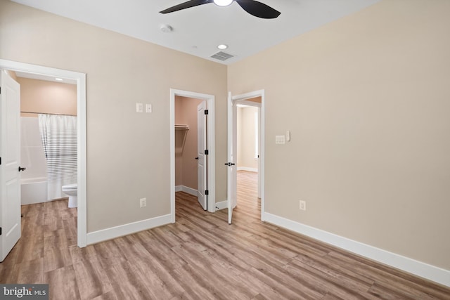 5570 Warren Dr, Huntingtown, MD 20639 - unfurnished bedroom with a spacious closet, light wood-style floors, baseboards, and a closet