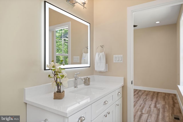 5570 Warren Dr, Huntingtown, MD 20639 - bathroom featuring vanity, wood finished floors, and baseboards