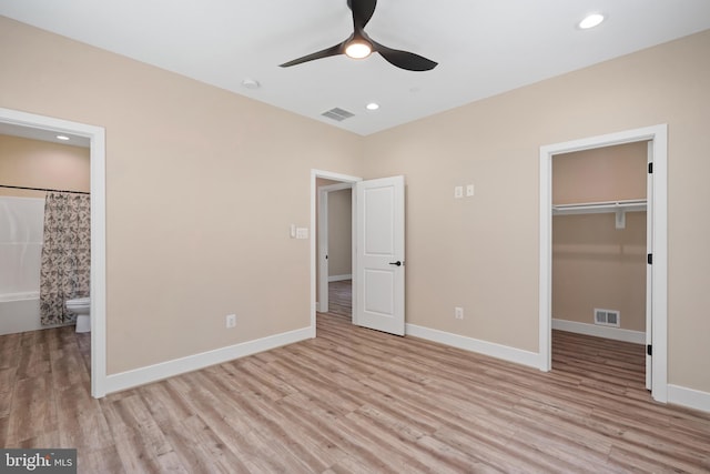 5570 Warren Dr, Huntingtown, MD 20639 - unfurnished bedroom featuring light wood-style floors, a spacious closet, baseboards, connected bathroom, and recessed lighting