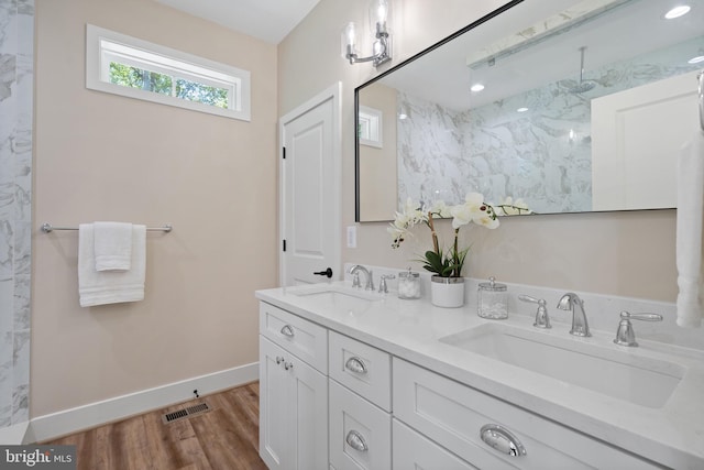 5570 Warren Dr, Huntingtown, MD 20639 - bathroom with double vanity, wood finished floors, a marble finish shower, and baseboards