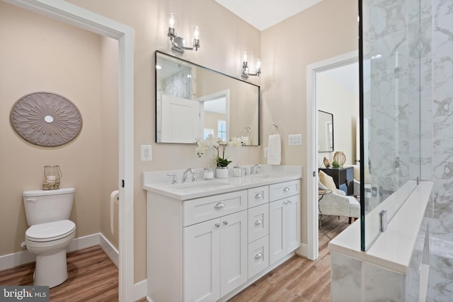5570 Warren Dr, Huntingtown, MD 20639 - bathroom featuring wood finished floors, double vanity, toilet, and baseboards