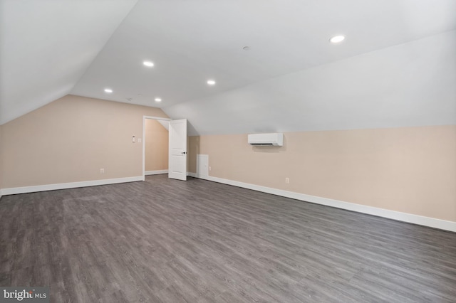 5570 Warren Dr, Huntingtown, MD 20639 - bonus room with a wall mounted air conditioner, dark wood finished floors, vaulted ceiling, baseboards, and recessed lighting