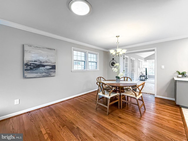 8002 Gosport Ln, Springfield, VA 22151 - dining area with baseboards, a chandelier, crown molding, and wood finished floors