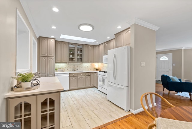 8002 Gosport Ln, Springfield, VA 22151 - kitchen featuring white appliances, ornamental molding, glass insert cabinets, decorative backsplash, and light countertops