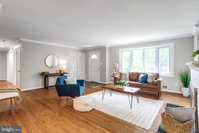 8002 Gosport Ln, Springfield, VA 22151 - living area with crown molding, baseboards, wood finished floors, and a fireplace