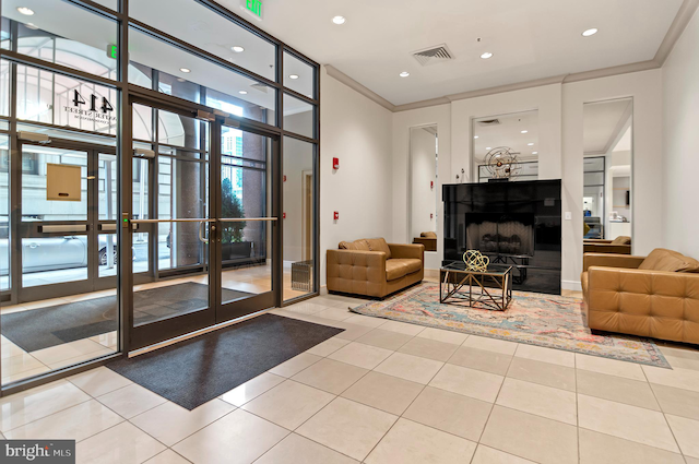 lobby featuring crown molding, expansive windows, and recessed lighting