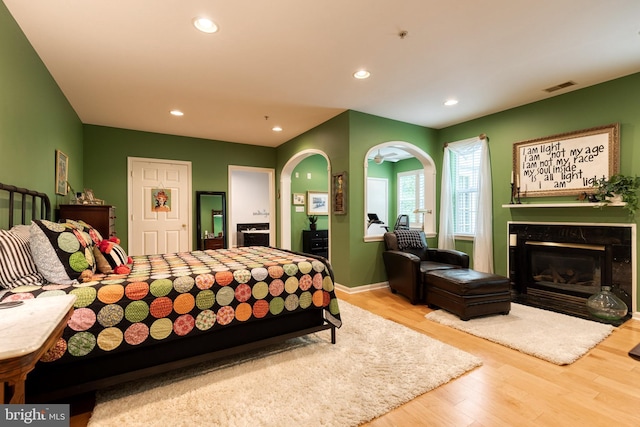 9663 Devedente Dr Unit 101, Owings Mills, MD 21117 - bedroom featuring a high end fireplace, recessed lighting, wood finished floors, arched walkways, and baseboards