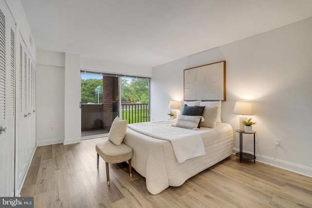 1300 Army Navy Dr Unit 124, Arlington, VA 22202 - bedroom with access to outside, light wood finished floors, and baseboards