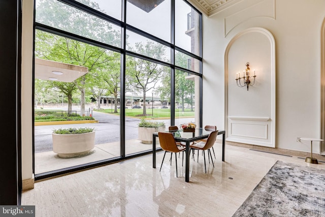 1300 Army Navy Dr Unit 124, Arlington, VA 22202 - dining space with plenty of natural light, a decorative wall, floor to ceiling windows, and a high ceiling
