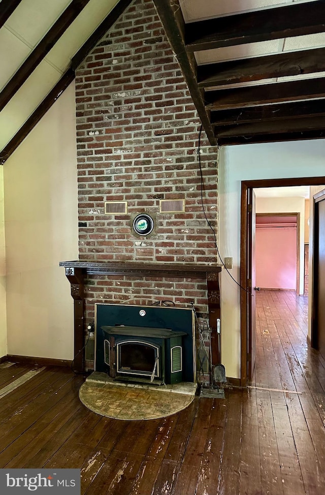 unfurnished living room with hardwood / wood-style floors and baseboards