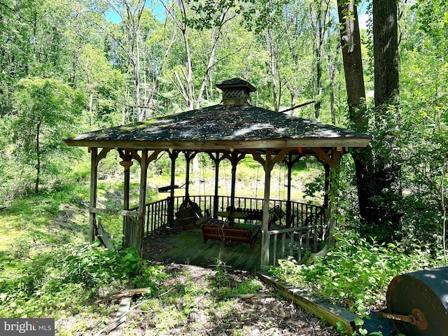 surrounding community featuring a gazebo and a deck