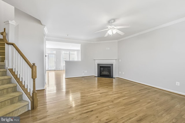 42952 Miltec Ter, Chantilly, VA 20152 - unfurnished living room featuring light wood-style floors, a ceiling fan, stairs, baseboards, and crown molding
