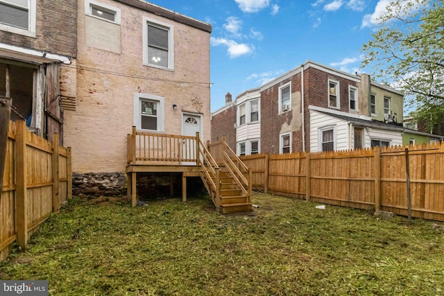 rear view of property with a fenced backyard