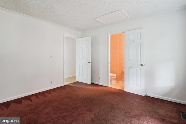 339 Gray Dr, Lusby, MD 20657 - unfurnished bedroom featuring attic access, a textured ceiling, carpet floors, ensuite bathroom, and baseboards