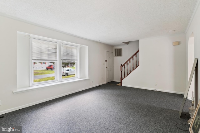 339 Gray Dr, Lusby, MD 20657 - entryway with stairs, a textured ceiling, dark carpet, and baseboards