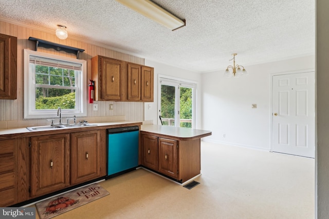 339 Gray Dr, Lusby, MD 20657 - kitchen featuring dishwashing machine, a sink, brown cabinetry, a textured ceiling, and ornamental molding