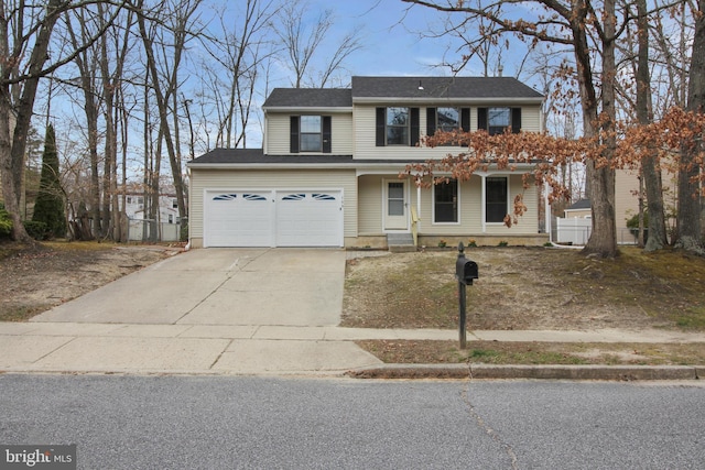 traditional-style house featuring driveway, covered porch, and a garage