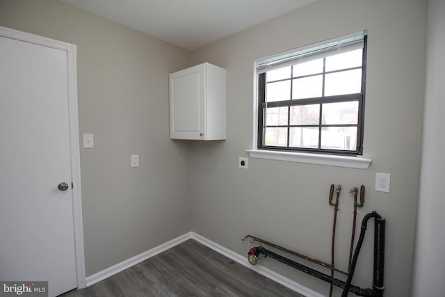 washroom featuring cabinet space, dark wood-style flooring, electric dryer hookup, and baseboards