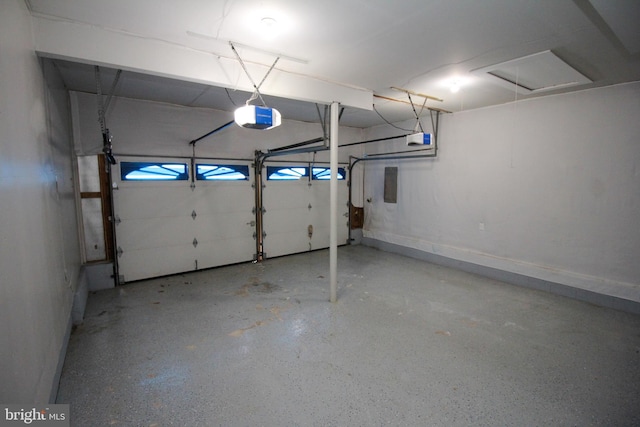 garage featuring a garage door opener and baseboards