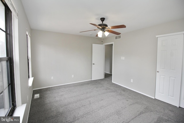 unfurnished bedroom featuring carpet floors, baseboards, and ceiling fan