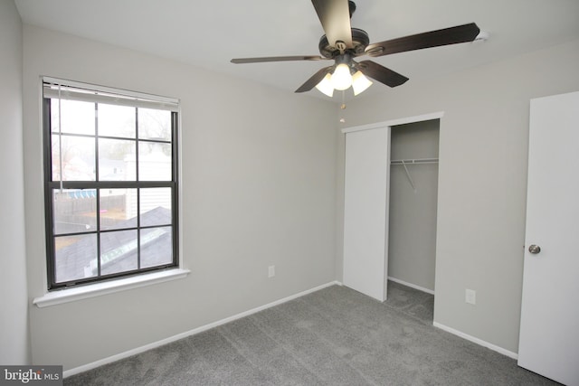 unfurnished bedroom featuring carpet flooring, a closet, baseboards, and a ceiling fan
