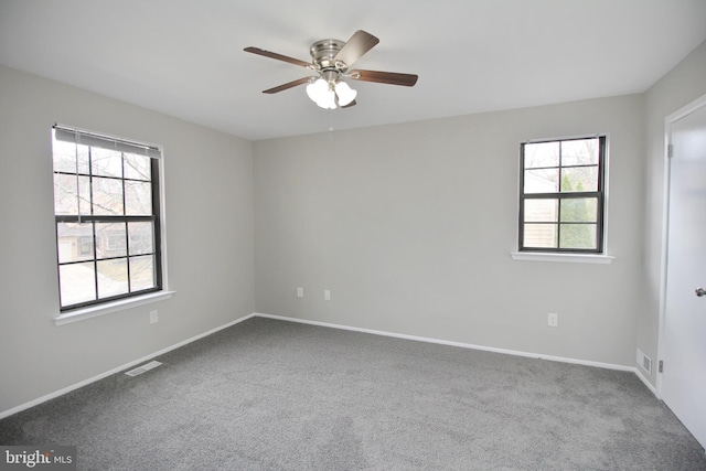 empty room featuring carpet, ceiling fan, and baseboards